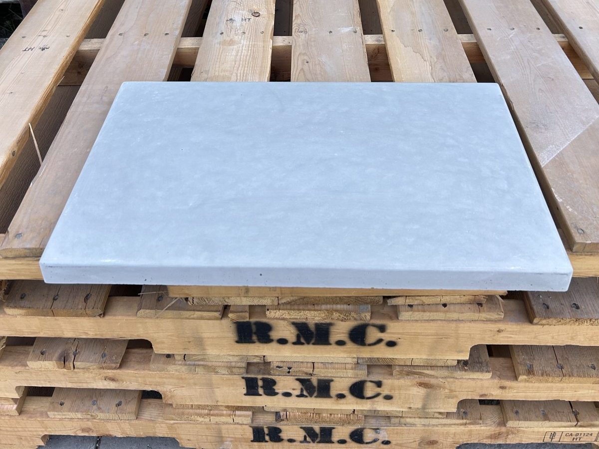 Flat concrete pool coping cap in light grey, 12 by 24 inches, on a Rocky Mountain Concrete pallet