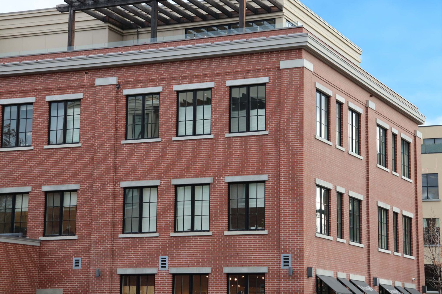 Wall caps and precast banding on a multi-storey brick building.