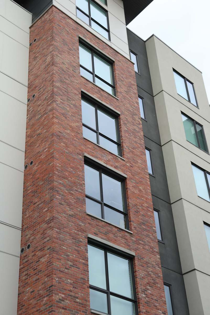 Precast window sills across a brick facade.