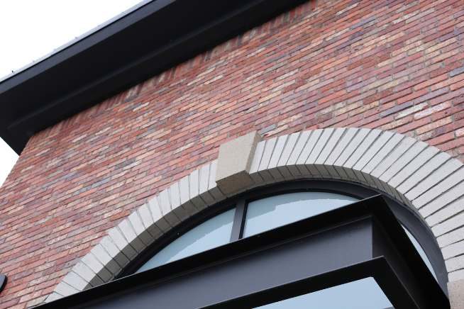 Custom curved precast on a brick archway.